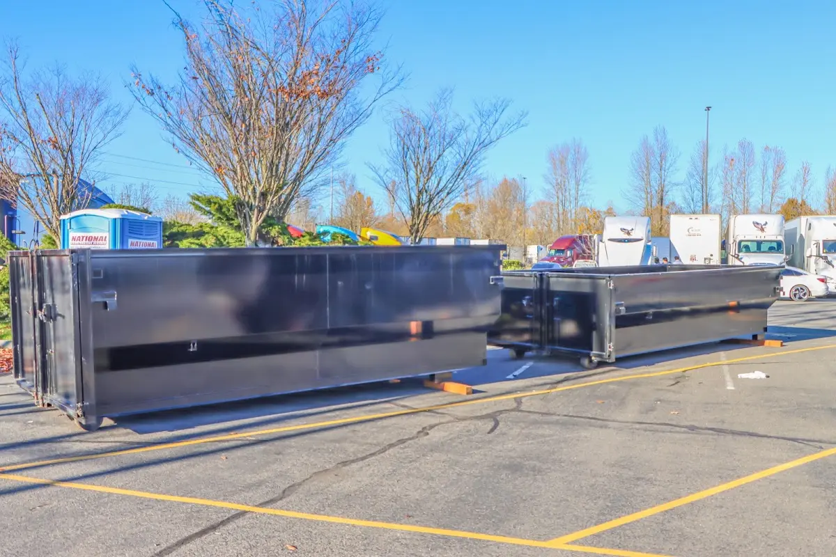 Professional dumpster rental service with roll-off container on residential driveway in Roselle